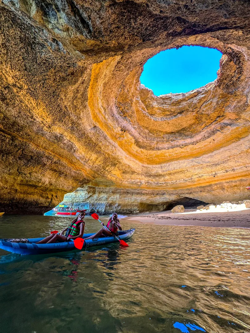 Kayakers inside the Benagil Cave with the iconic skylight above